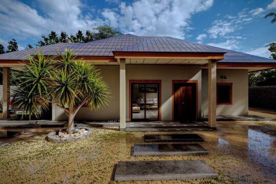 a small house with a pool in front of it